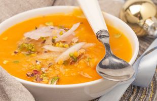 Red lentil soup with confit onion and chopped pistachios