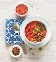 Dahl of red lentils, roasted tomatoes and crispy pumpkin seeds