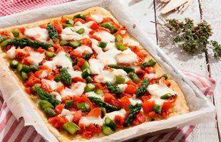 Pizza di riso e patate con mozzarella, pomodori e asparagi